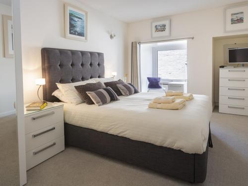 a bedroom with a large bed with a large headboard at Leeside in Dartmouth