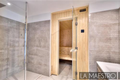 a shower with a glass door in a bathroom at Domaine du Peyrouas in Saint-Jeannet
