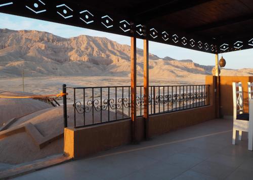 a balcony with a view of the desert and mountains at Malkata House in Luxor