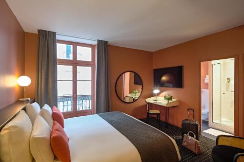 ナントにあるMercure Nantes Centre Passage Pommerayeのベッドと窓が備わるホテルルーム