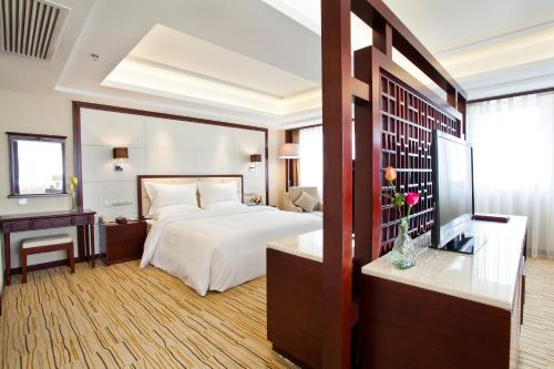 a hotel room with a bed and a desk at Beijing Guizhou Hotel in Beijing