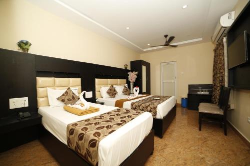 Rúm í herbergi á Hotel Ragavendra Rameswaram