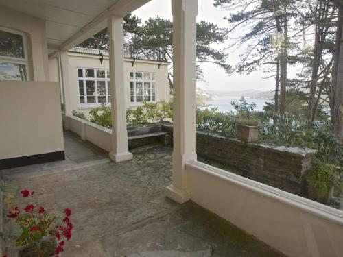 a porch with a view of the ocean from a house at 4 Ringrone in Salcombe