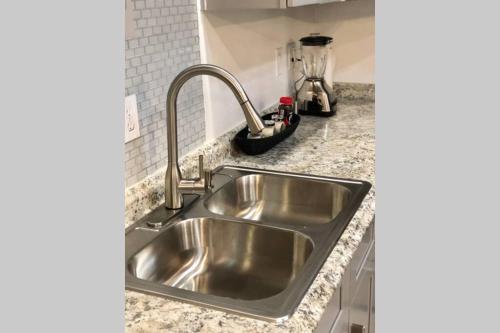a stainless steel kitchen sink in a counter top at NEW 2 BEDROOM LUXURY APARTMENT -GREAT LOCATION -MODERN in Puerto Peñasco