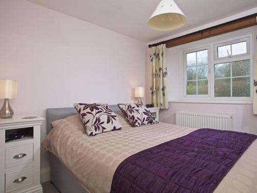 a bedroom with a bed and a window at Cloverwell in Kingsbridge