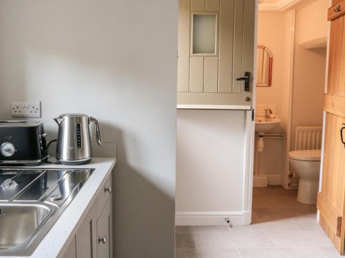 a kitchen with a sink and a counter top at Croft Cottage in Skipton