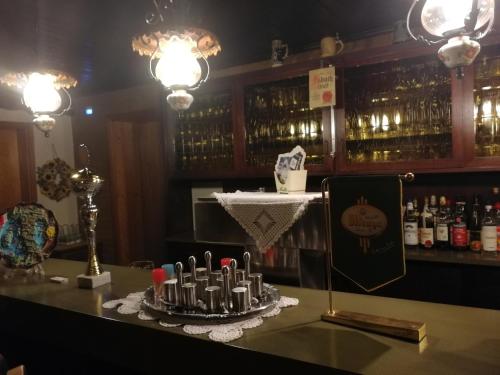 a bar with a table with a tray of candles at Gasthaus Hochwald in Hattgenstein