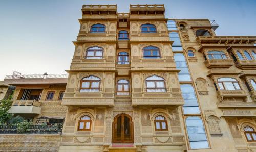 a building with a tower on the side of it at Treebo Trend Chandrangan Excellency 1 Km From Jaisalmer Fort in Jaisalmer