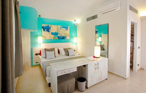 a bedroom with a bed and a desk in it at VOI Floriana Resort in Simeri Mare