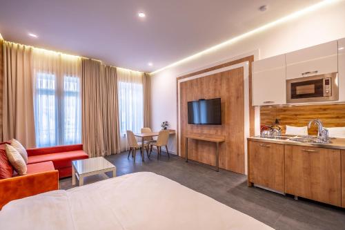 a hotel room with a bed and a living room at 5 STAR APART HOTEL in Tbilisi City