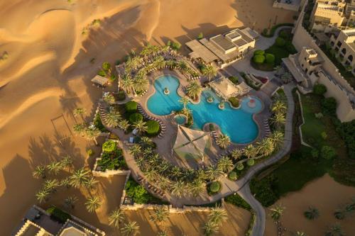 an aerial view of a resort with a pool at Anantara Qasr al Sarab Desert Resort in Jurayrah