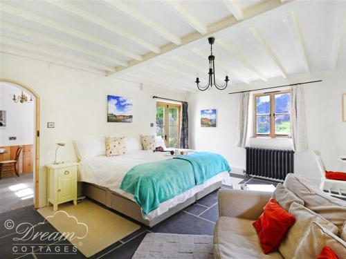 a bedroom with a large bed and a couch at Valley View Farm Annexe in Uplyme