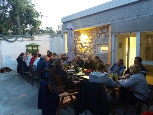 a group of people sitting at tables at a restaurant at Silba Otium in Silba