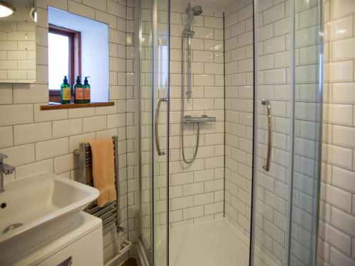 a bathroom with a shower and a sink at Weir Cottage in Maidstone
