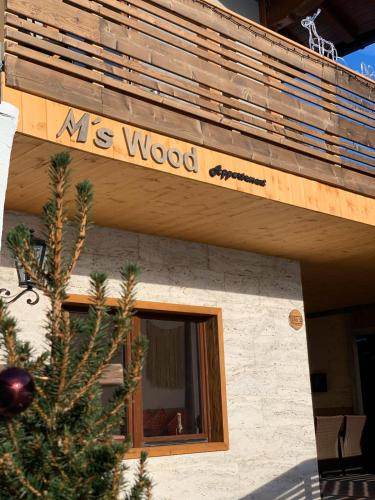 a sign that says me wood on the side of a building at M's Wood Appartement in Maishofen