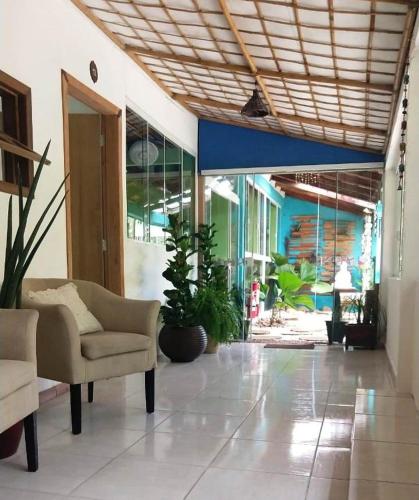 a lobby with a couch and chairs in a building at Pousada Gaucha Caiobá in Matinhos
