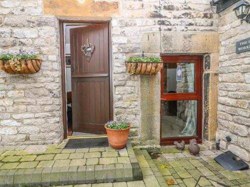 two potted plants sitting in front of a door at The Old Workshop in Castleton