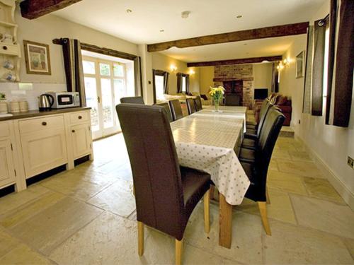 a dining room with a table and chairs in a kitchen at The Rindle in Leek
