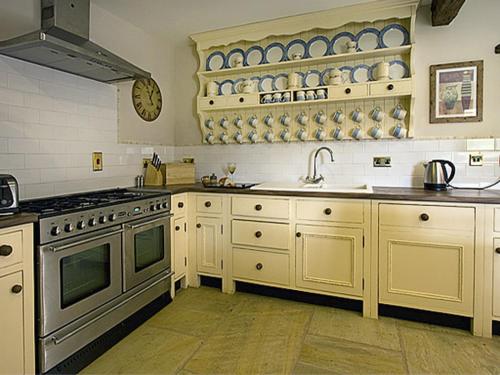 a large kitchen with a stove and a sink at The Rindle in Leek