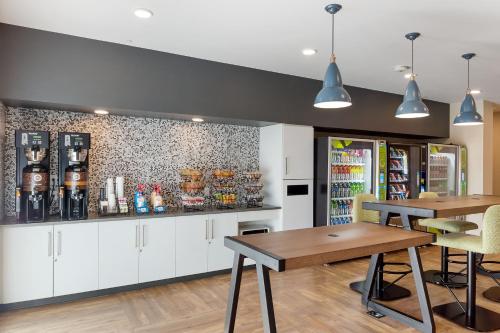 a dining room with two tables and a counter at Extended Stay America Premier Suites - Phoenix - Chandler - Downtown in Chandler