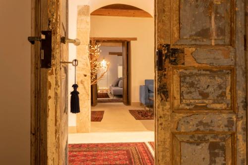 an open door to a hallway with a living room at Isabella di Castiglia Apartments in Siracusa