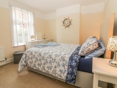 a bedroom with a bed and a clock on the wall at Sunvale in Teignmouth
