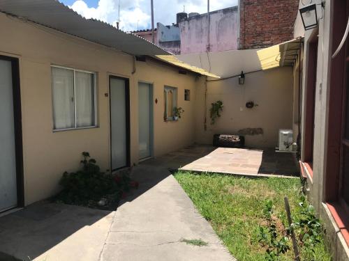 an empty alleyway next to a house with a building at Posada Casa de Borgoña in Salta
