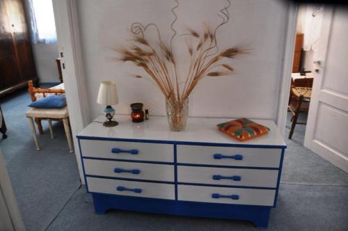 a dresser with a vase on top of it at CASA LELA 1...όπως μια φορά...like once in Míloi