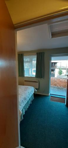 a bedroom with a bed and a large window at Church Farm in Stratford-upon-Avon