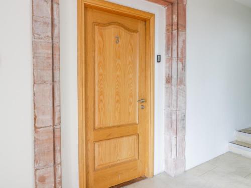 a wooden door in the corner of a room at Duplex in Moffat