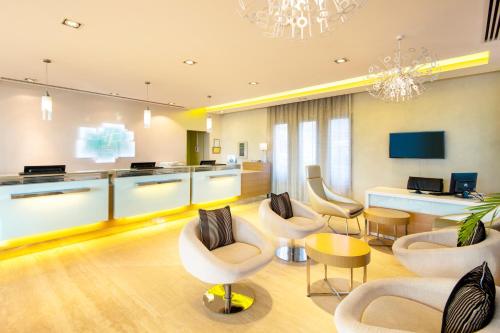 a living room with chairs and a table at Holiday Inn Muscat AlSeeb by IHG in Muscat