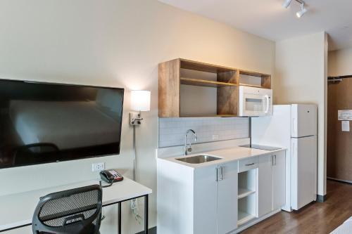 a small kitchen with a sink and a refrigerator at Extended Stay America Premier Suites - Phoenix - Chandler - Downtown in Chandler