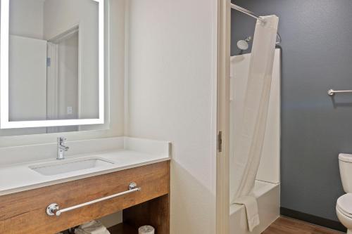 a bathroom with a sink and a toilet and a mirror at Extended Stay America Premier Suites - Phoenix - Chandler - Downtown in Chandler