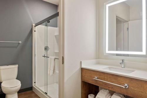 a bathroom with a sink and a toilet and a mirror at Extended Stay America Premier Suites - Phoenix - Chandler - Downtown in Chandler