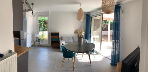 a kitchen and dining room with a table and chairs at Boost Your Immo Six Fours Les Plages 231 in Six-Fours-les-Plages