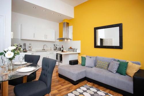 a living room with a couch and a table at Oakstays City Centre Gem in Newcastle upon Tyne