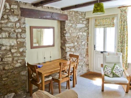 a dining room with a wooden table and chairs at Bridle Cottage in Settle
