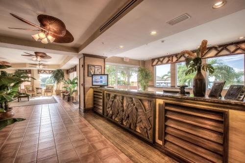 a large lobby with a bar with wood paneling at Lovers Key Resort in Fort Myers Beach
