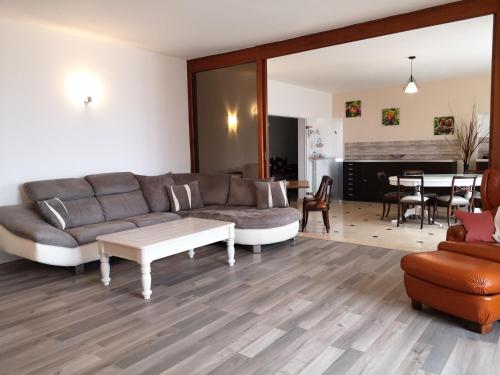 a living room with a couch and a table at La Marquière - Gite Val de Loire in Onzain