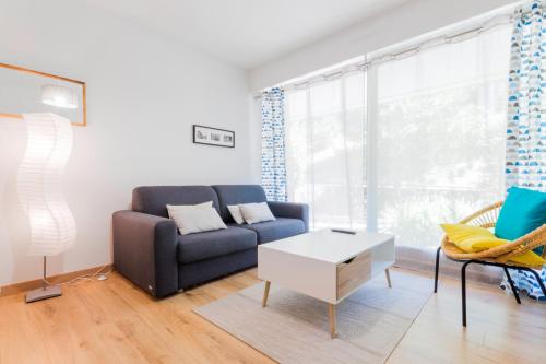 a living room with a couch and a table at T2 Port de Vannes in Vannes
