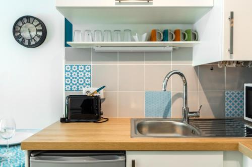 a kitchen with a sink and a counter at T2 Port de Vannes in Vannes