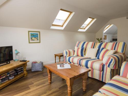 a living room with a couch and a coffee table at 5 Chichester Court in Kingsbridge