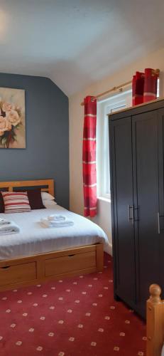 Ένα ή περισσότερα κρεβάτια σε δωμάτιο στο The Merrydale Guest House