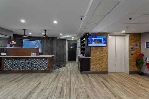 an office lobby with a reception desk and a tv at Best Western West Lebanon-Hanover in West Lebanon