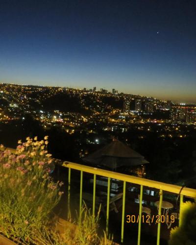 a view of a city at night with lights at Posada Verde Natura in Viña del Mar