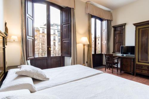 Postel nebo postele na pokoji v ubytování Hotel Plaza Nueva