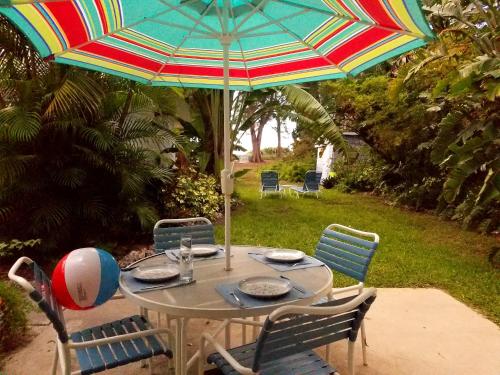 a table with an umbrella on a patio at Bamboo Apartments in Holmes Beach