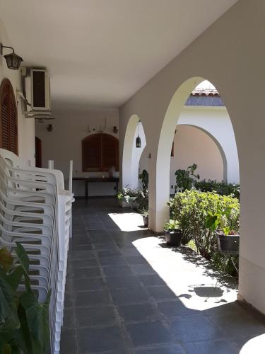 a courtyard with arches and plants in a building at Pousada Santa Fé in Aparecida
