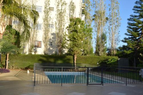 a building with a swimming pool in front of a building at Raise Cosy Studio with pool in Limassol in Limassol