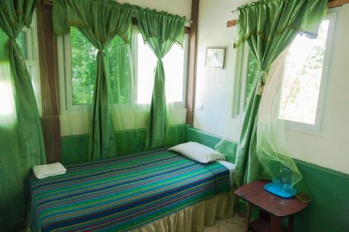 
A bed or beds in a room at Zapote Tree Inn
